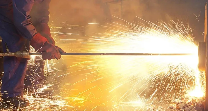 Metallbearbeitung mit starkem Funkenflug in einer industriellen Produktionsumgebung